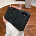 Black imitation leather magnetic charging case for Apple iPhone on a table.