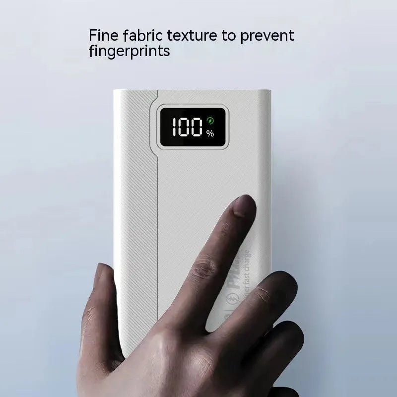 Large capacity power bank in black or white with plastic shell showing charging ports