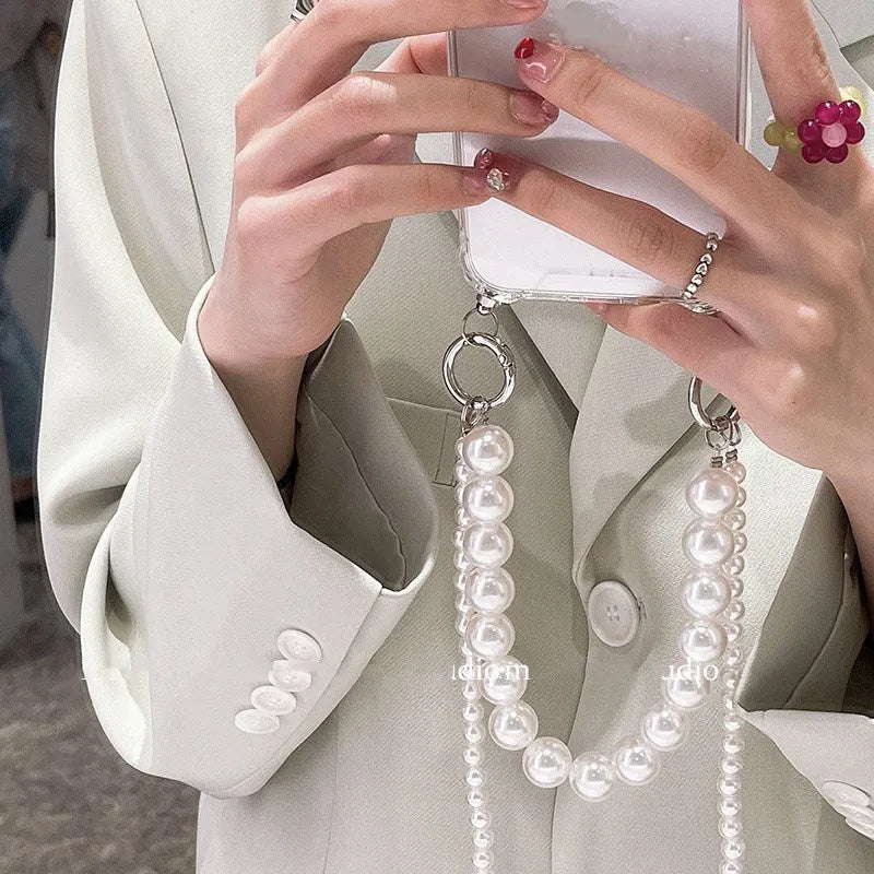 Soft mobile phone case with a white pearl charm chain attached, shown in a selected colour.