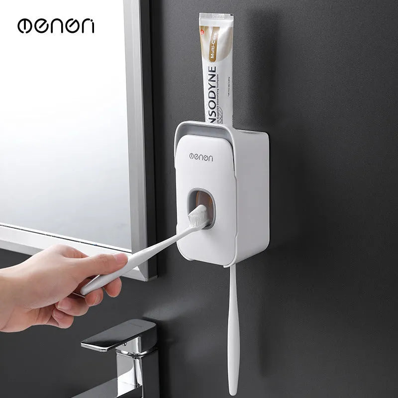 Automatic toothpaste dispenser wall mounted unit in blue, grey or pink colours with no-drip nozzle