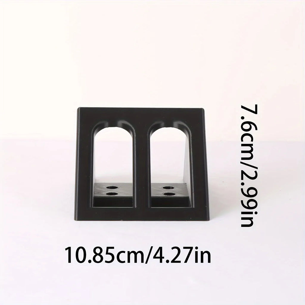 Black punk-style plastic pistol display stand on a flat surface.