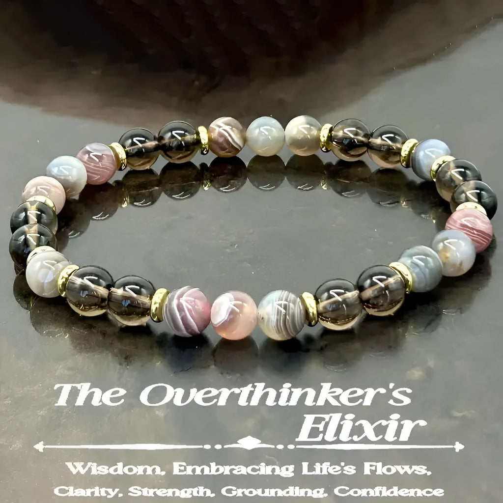 Close-up of a multi-element natural stone bracelet with tigereye, obsidian, red tiger stone, and gold geometric beads