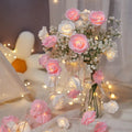 LED rose-shaped fairy light string with PV foam lamps on a 1.5m battery-powered cord for indoor holiday decoration.