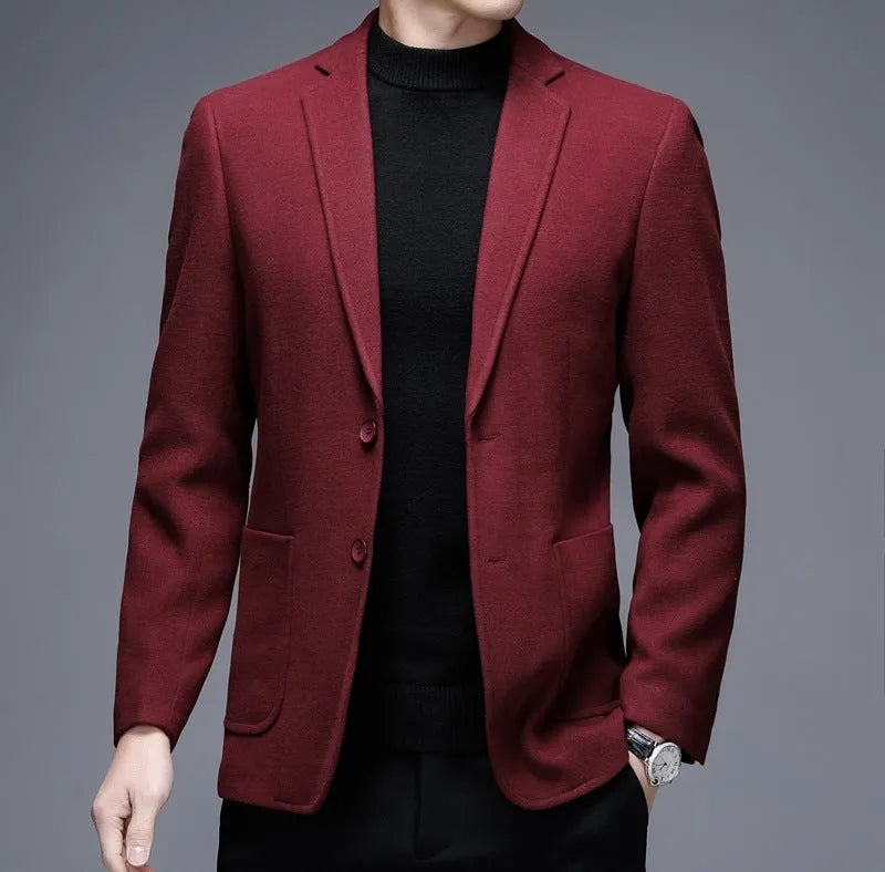 Men's solid colour woolen suit jacket with loose fit and round hem in winter setting.