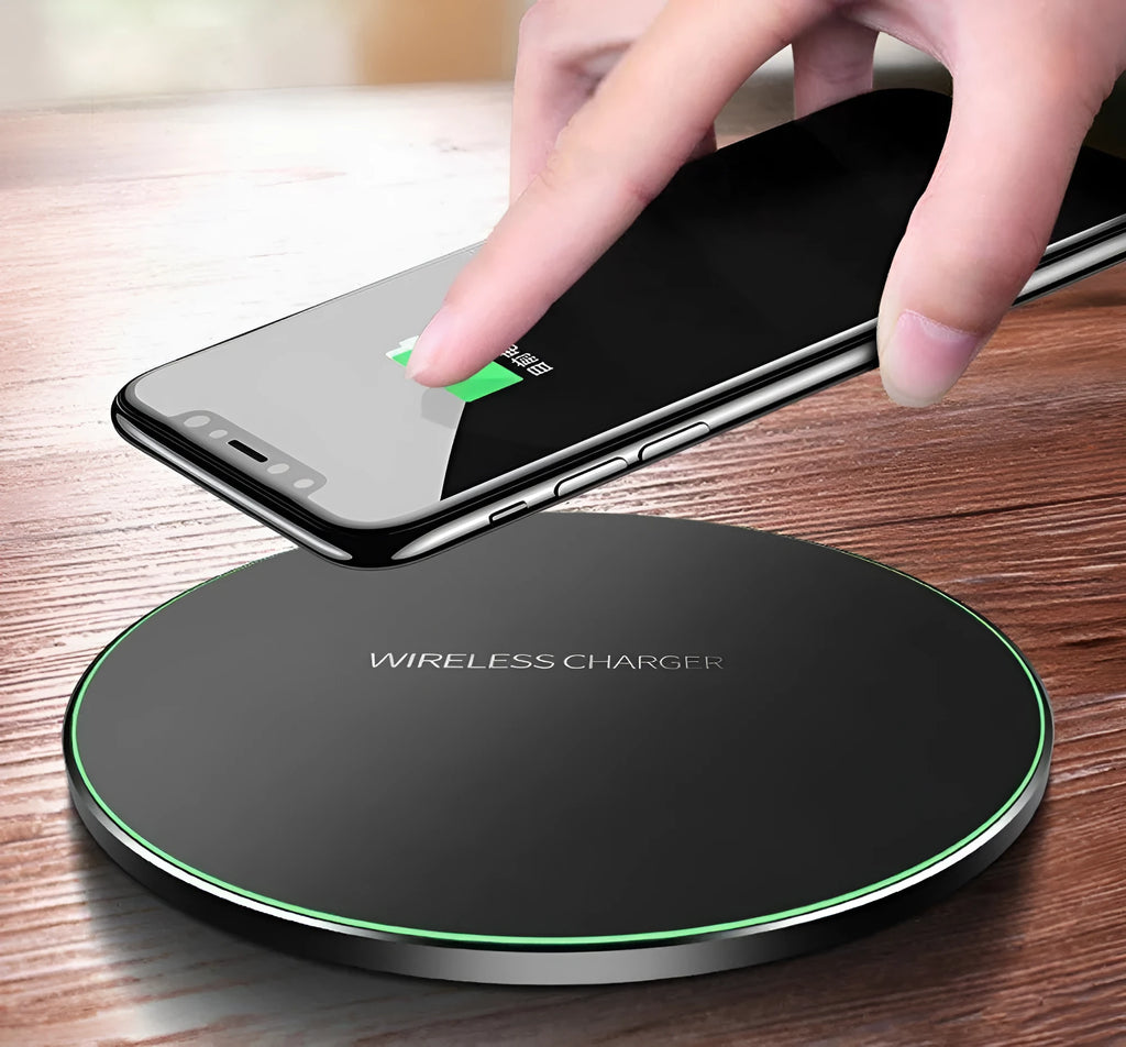 Ultra-thin black wireless charging pad with USB cable on desk