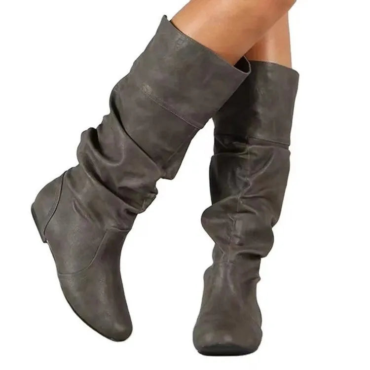Women's flat round toe slip-on ankle boots in black PU leather with a high shaft and rubber sole.
