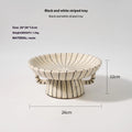 Black and white striped synthetic resin fruit plate on table