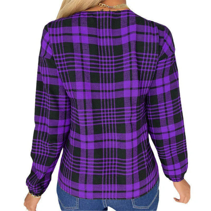 Women's purple, grey, and red plaid loose fit shirt with regular sleeves on a hanger.