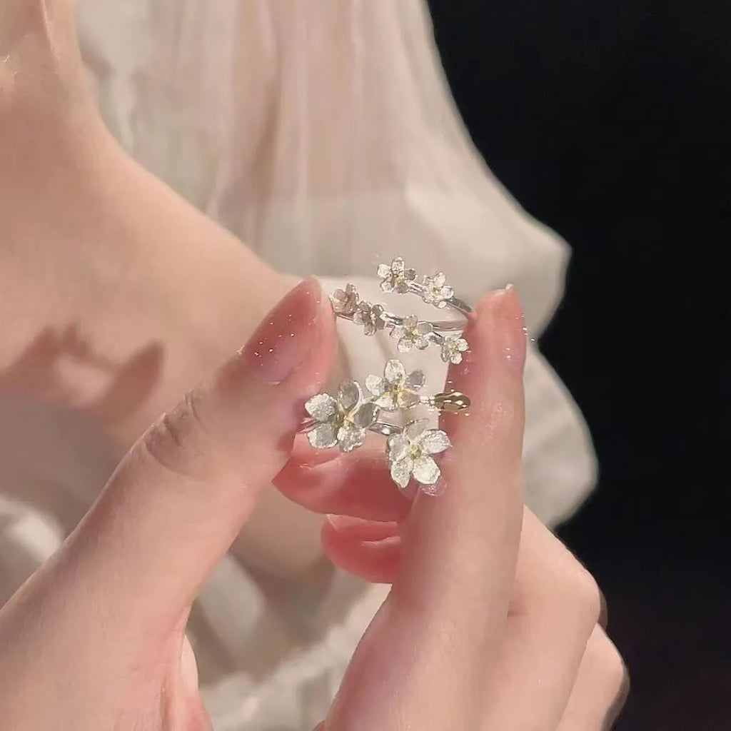 3D jasmine flower adjustable ring in zinc alloy with electroplated finish on a hand.