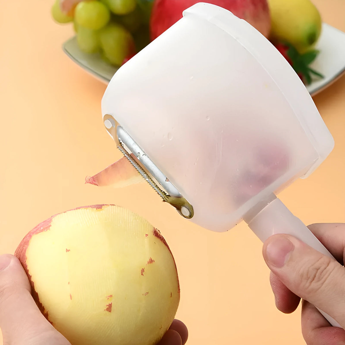 Stainless steel fruit peeler with PP handle, shown in pink or blue, modern minimalist kitchen gadget for fruit peeling