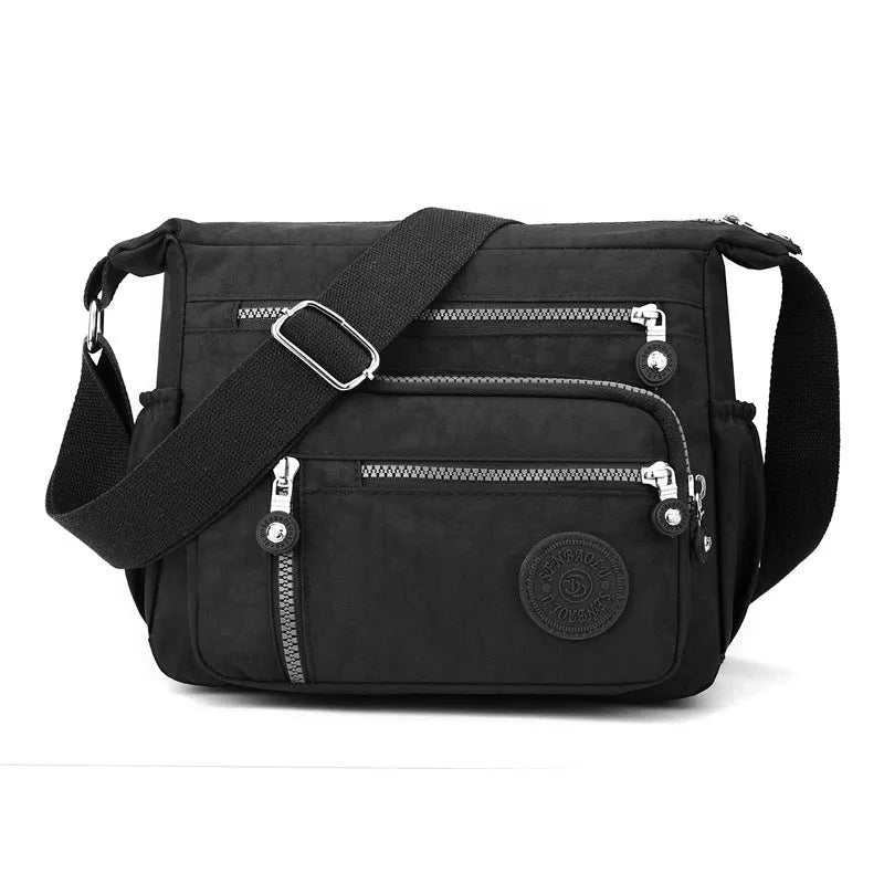 Soft nylon shoulder messenger bag in square vertical design, shown in grey colour.
