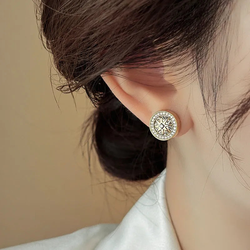Pair of copper stud earrings with real gold plating and inlaid zircon in an eight-pointed star shape for women