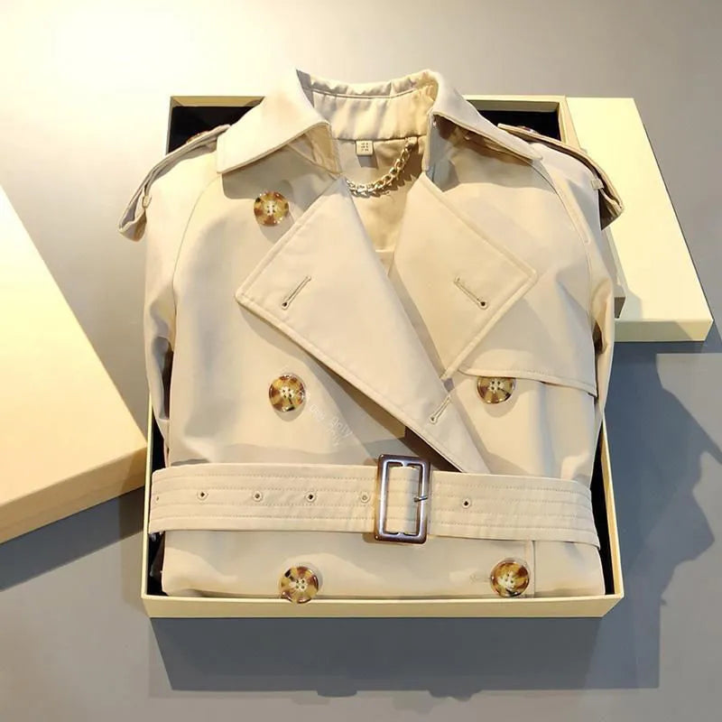 Khaki double-breasted polyester trench coat for women with flight sleeves on a hanger.