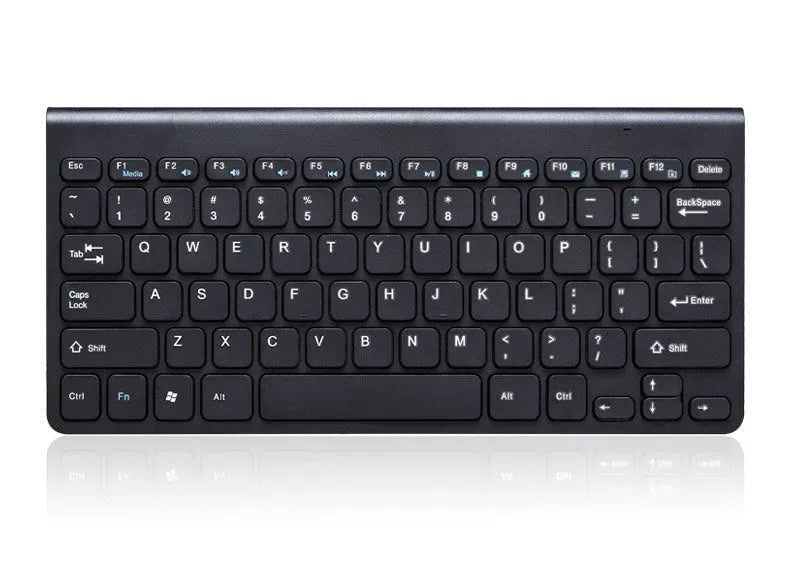 Black and white wireless keyboard and mouse set on a wooden desk.