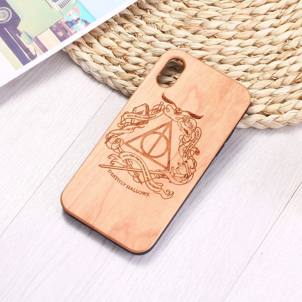 Wooden mobile phone case with laser-carved wood back and black TPU bumper frame for iPhone.