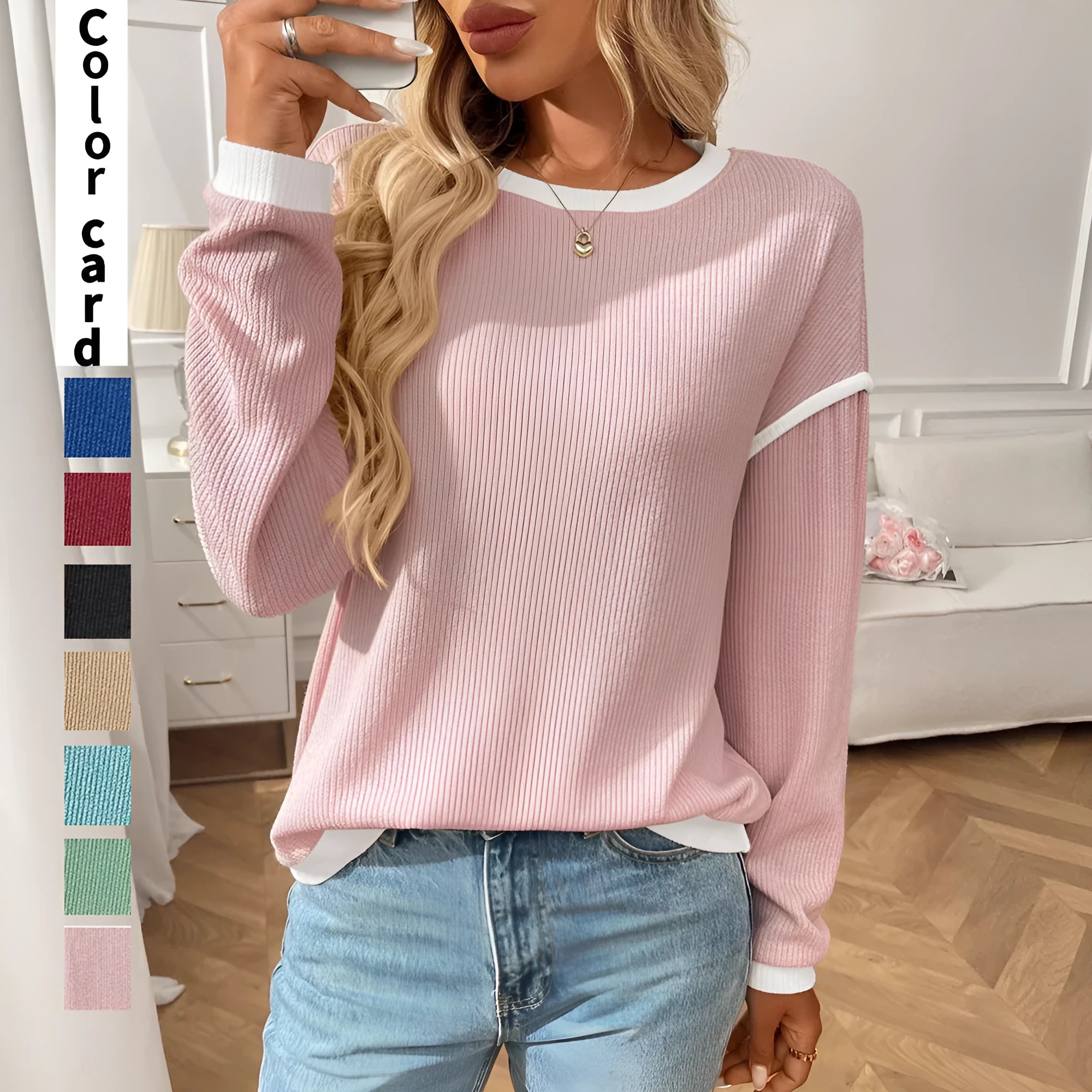 Women's loose-fitting long-sleeve polyester top in a round-neck pullover style on a hanger.