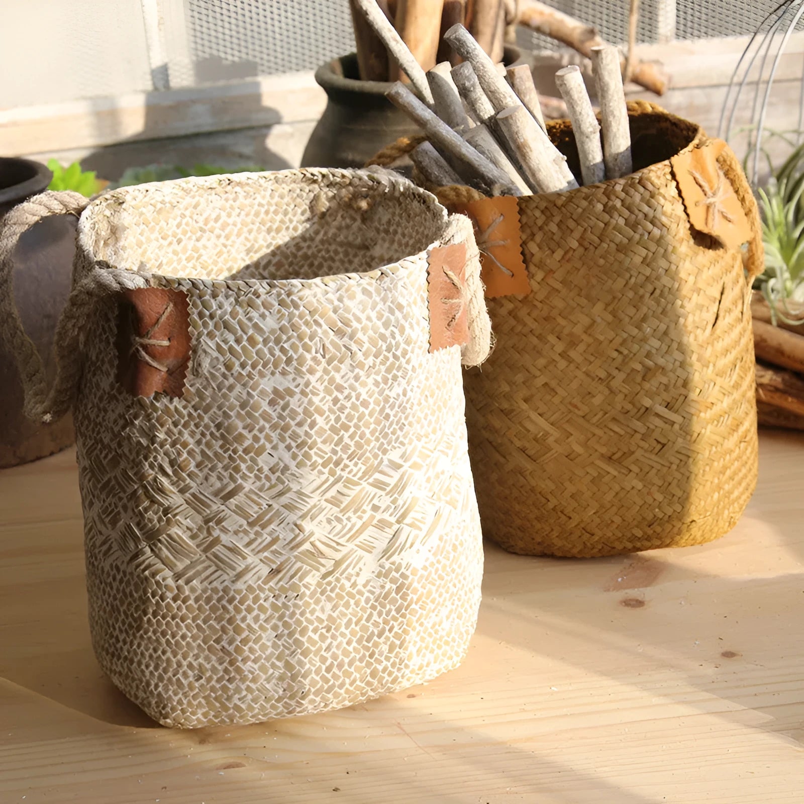 Hand woven seagrass basket in brown, size L, on a wooden surface