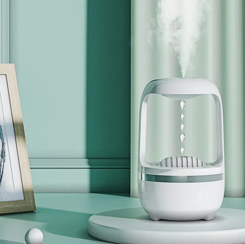 Anti-gravity humidifier with water droplet effect on desk next to USB cable