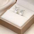 Bow-shaped women's earrings with round imitation pearl detail, electroplated alloy, Korean style, one pair
