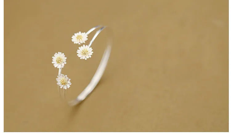 S925 sterling silver double daisy bracelet on a plain background, showing two daisy-shaped elements in a layered design
