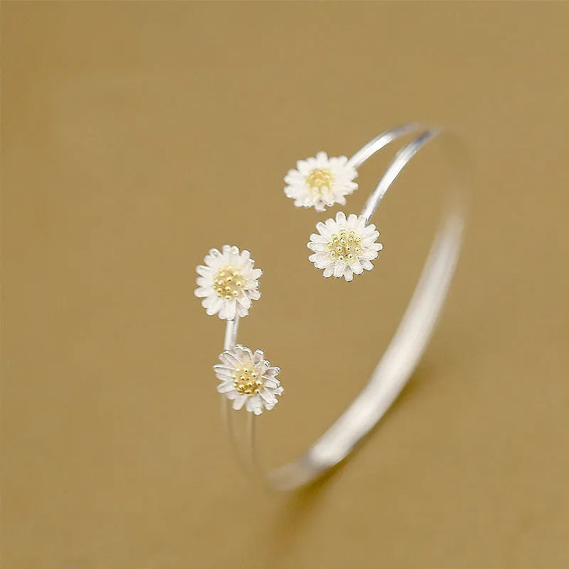 S925 sterling silver double daisy bracelet on a plain background, showing two daisy-shaped elements in a layered design