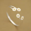 S925 sterling silver double daisy bracelet on a plain background, showing two daisy-shaped elements in a layered design