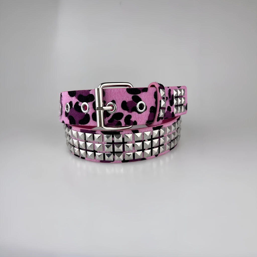 Punk women's belt with metal pyramid rivets in animal print patterns, showing pin buckle fastening