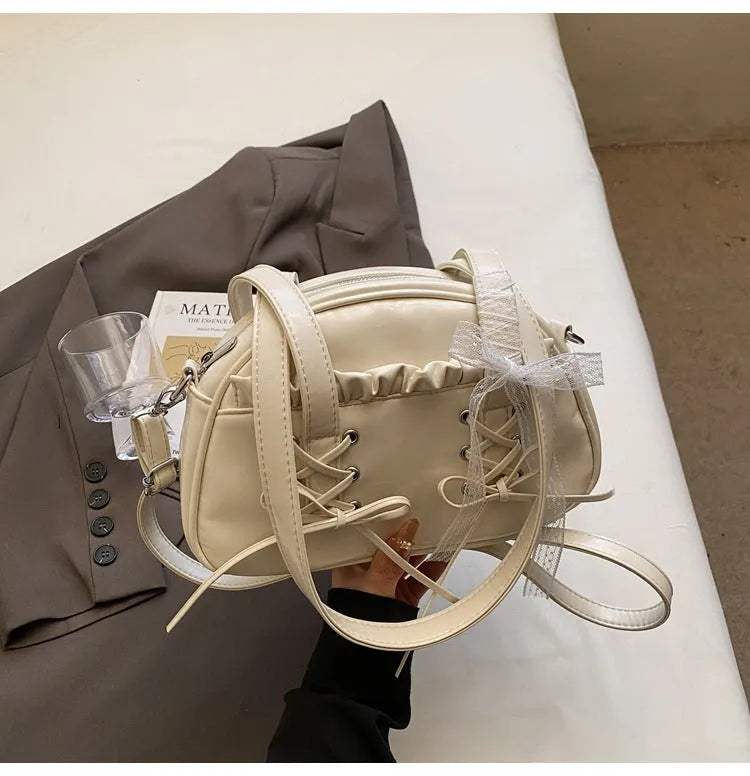 Casual ladies shoulder handbag with bandage bow detail in PU material showing mobile phone compartment