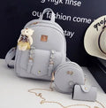 Women's three-piece PU leather bag set showing backpack, shoulder bag and card purse in matching colour.