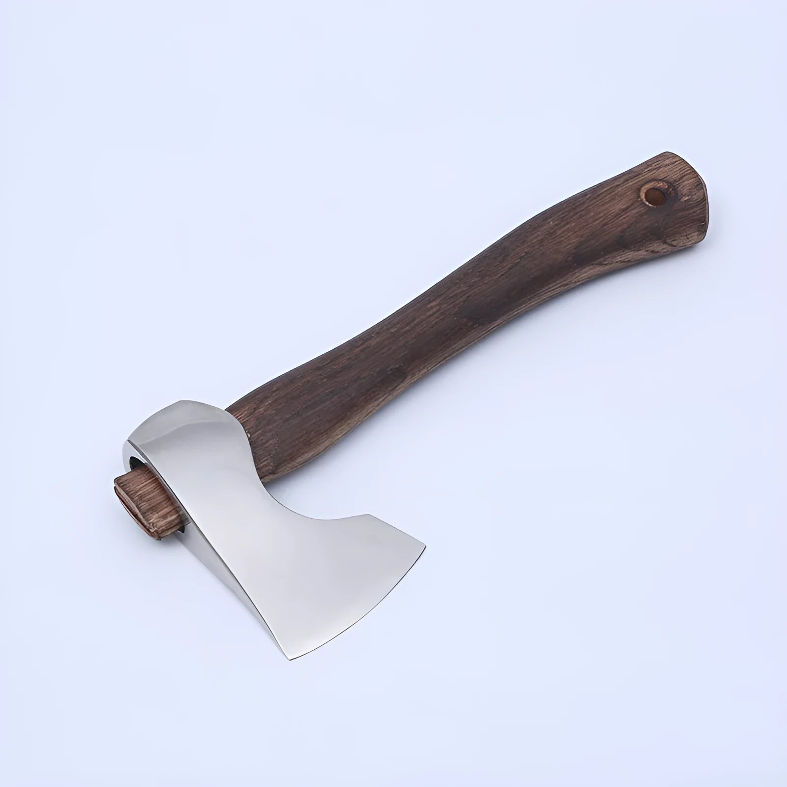 Camping axe with high carbon steel head and wooden handle on a neutral background.