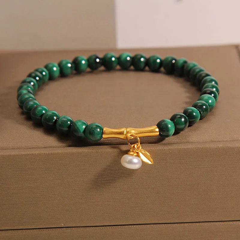 White crystal lucky bamboo bracelet with adjustable closure on a wrist.