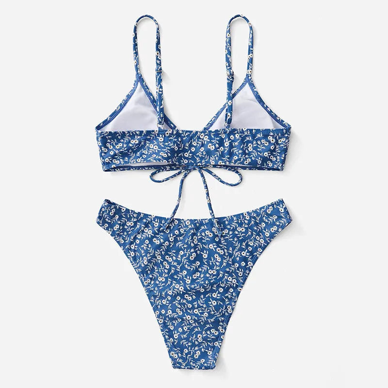 Blue polyester swimsuit three-piece set showing top and shorts, laid flat.