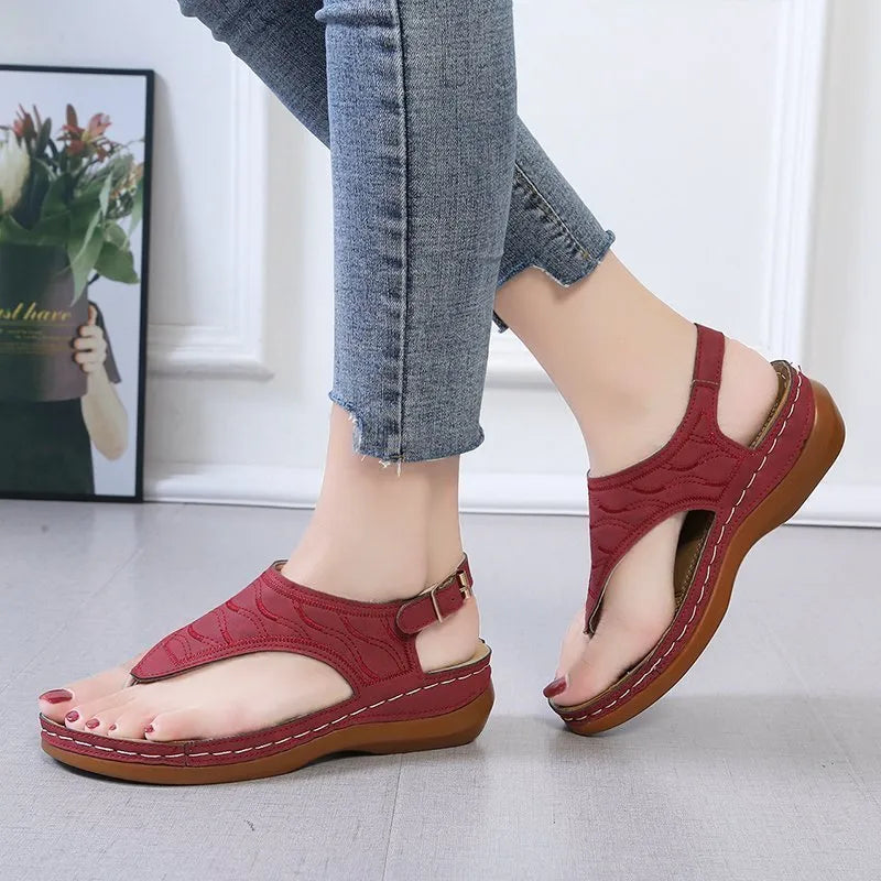 Women's wedge heel sandal in a solid colour with an adjustable back strap buckle.