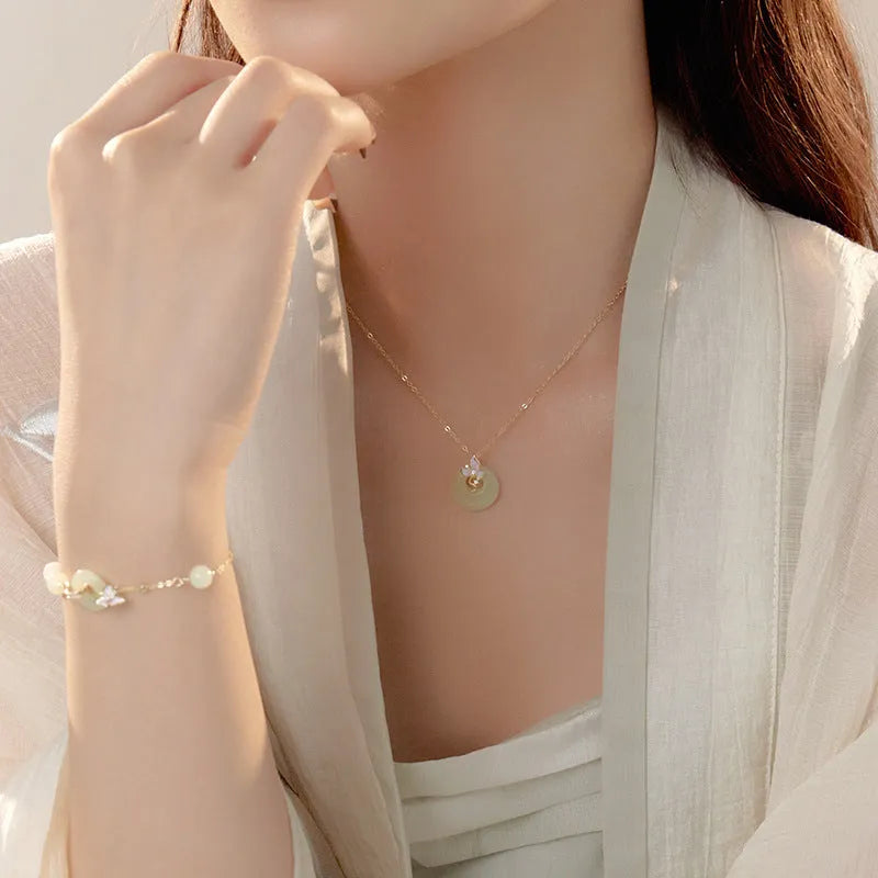 Silver orchid necklace for girls with floral geometry pendant and a secure peace buckle clasp on an O-ring chain.