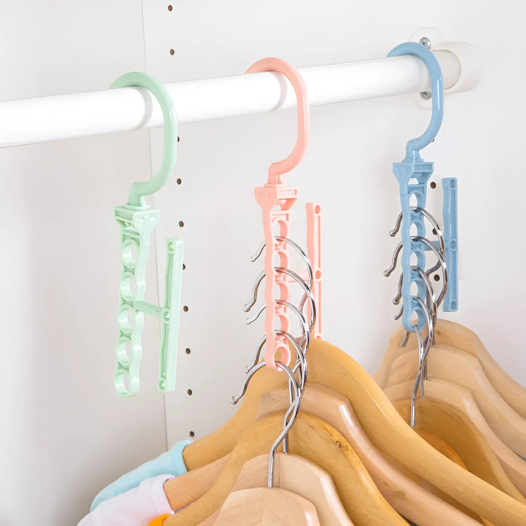 Blue revolving plastic wardrobe hanger with five arms and a top handle for rotation.