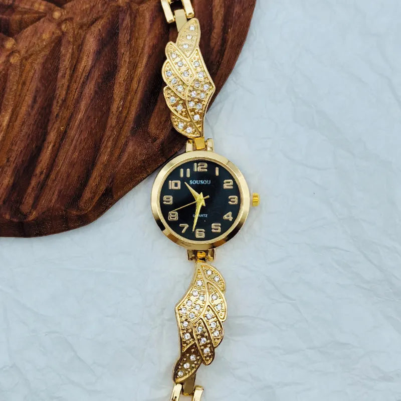 Women's stainless steel watch with round dial showing gold surface colour and vachette clasp