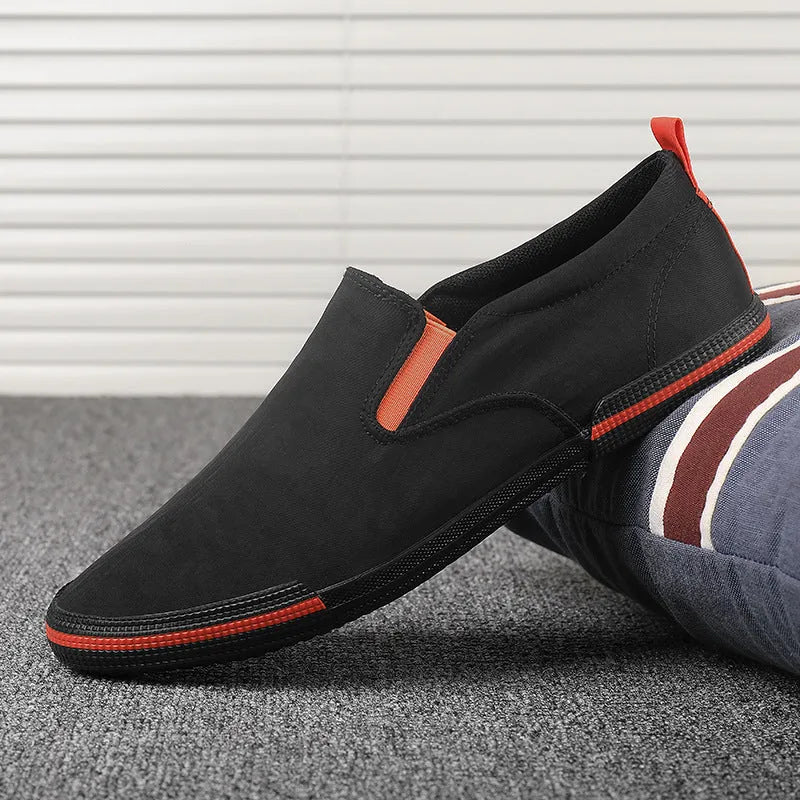 Men's low-top casual canvas shoes in grey, black orange, or khaki with vulcanised rubber soles.