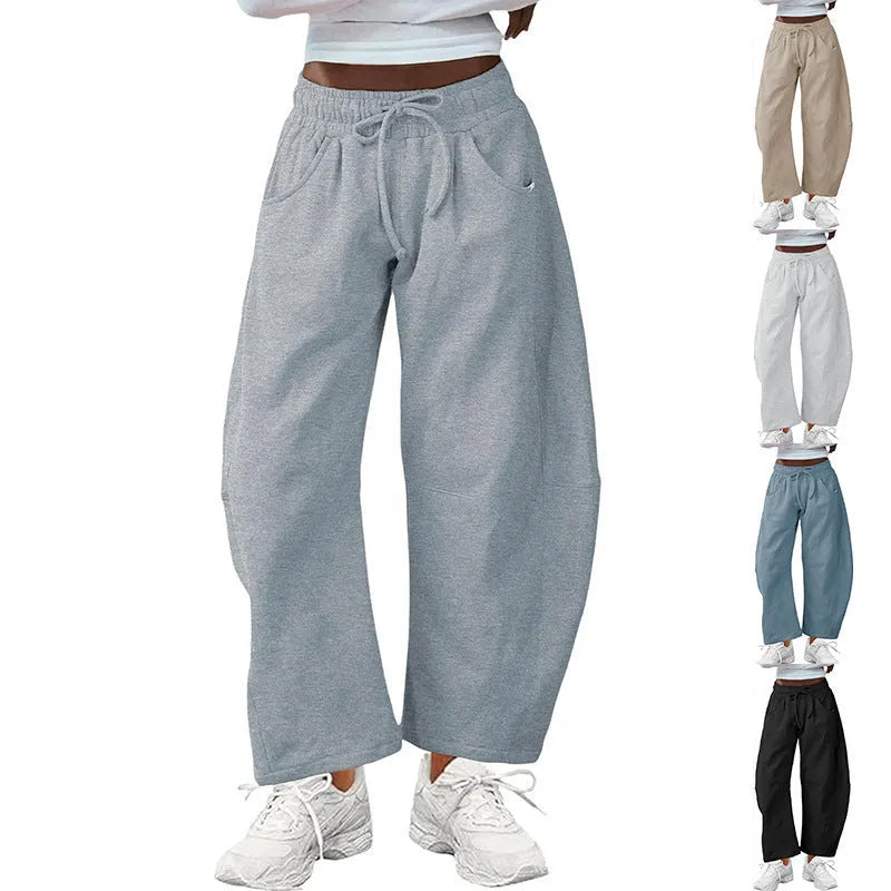 Loose cropped sweatpants with drawstring waist and side pockets in street fashion styling