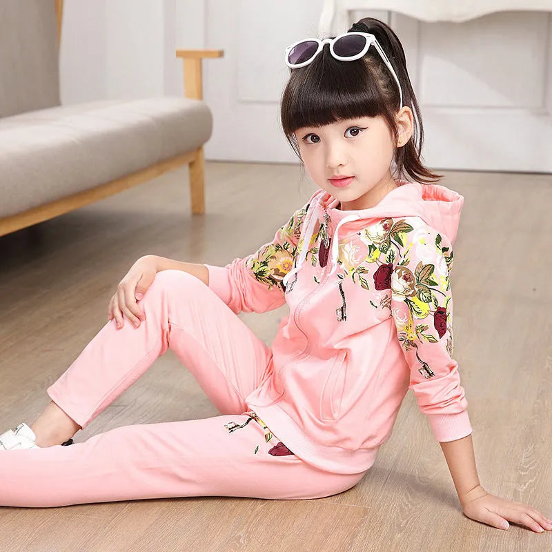 Children's pink hooded tracksuit set with long sleeves and matching trousers.