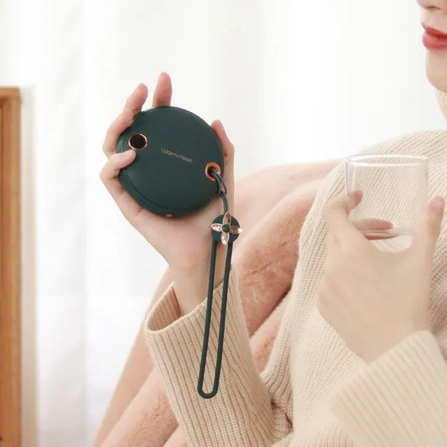 Green portable power bank with digital display, functioning as a hand warmer, shown next to its USB Type-C cable.