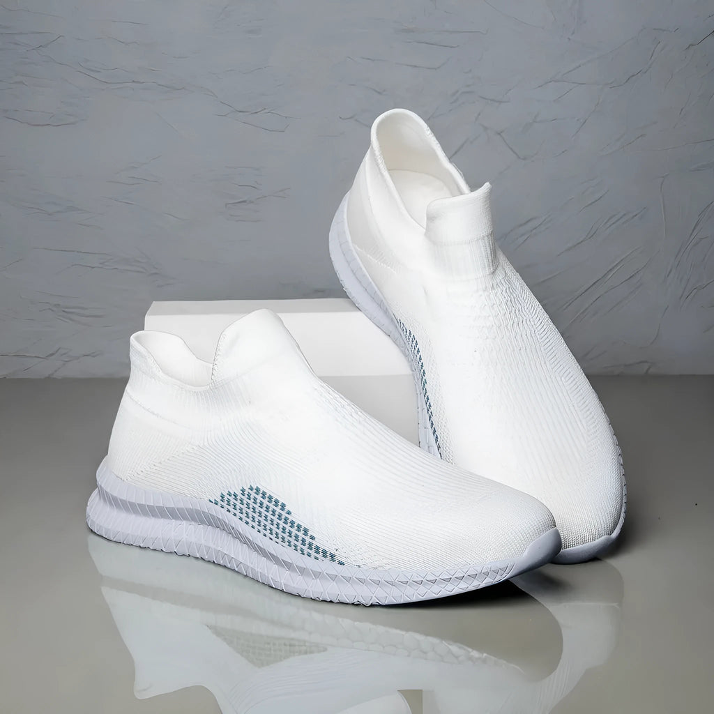 Men's white low-top fabric casual sneakers with round toe and flat sole on a neutral background.