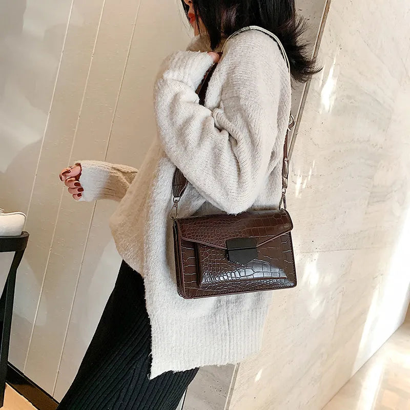 Vintage-style crossbody bag in PU material showing black, brown, khaki and red colour options