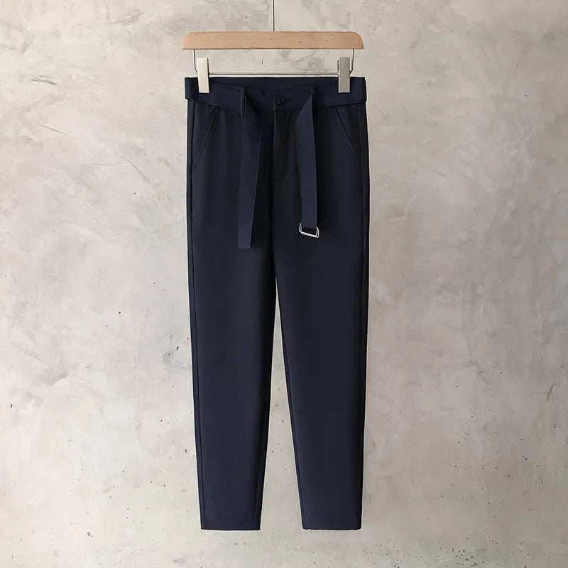 Boy wearing slim straight grey wool blend business casual trousers with a tapered fit