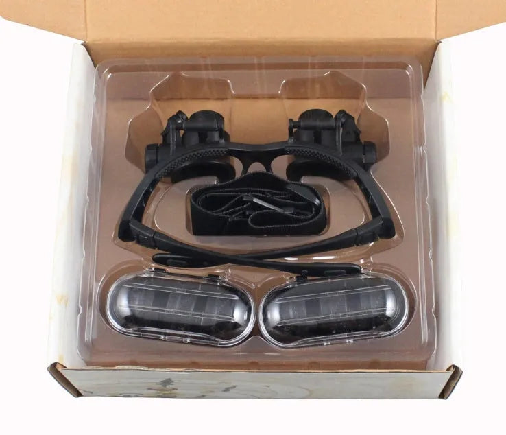 Black hands-free magnifying glasses with LED lights and multiple interchangeable lenses for precision repair work.