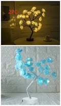 Rose flower LED table lamp with warm white glow on a flat surface, showing PE cotton flowers and bonsai tree shape