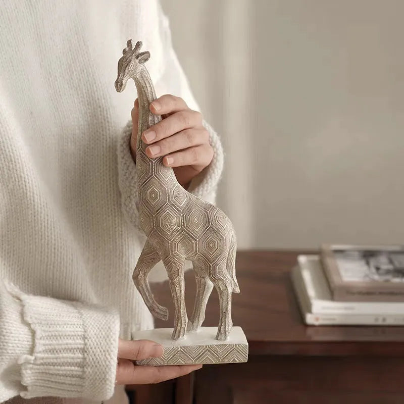 Wood colour European style resin giraffe ornament measuring 30.5 cm tall.