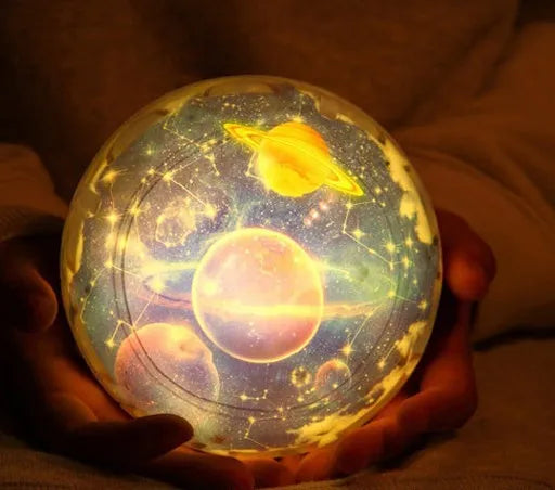 Galaxy projector lamp with diamond-shaped shell showing earth pattern on a table