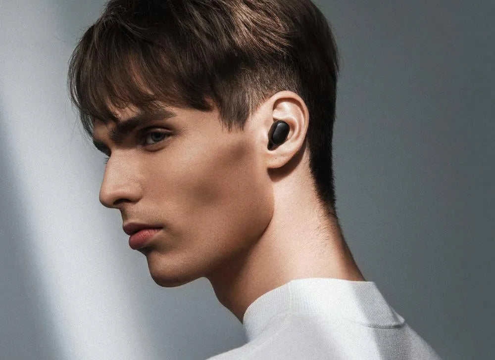 Black Redmi AirDots 2 true wireless earbuds and charging case on a white background