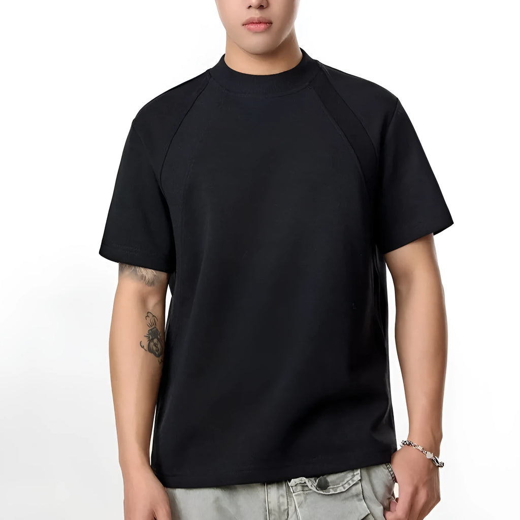 Men's loose black short sleeve top with textured air layer stitching on a grey background