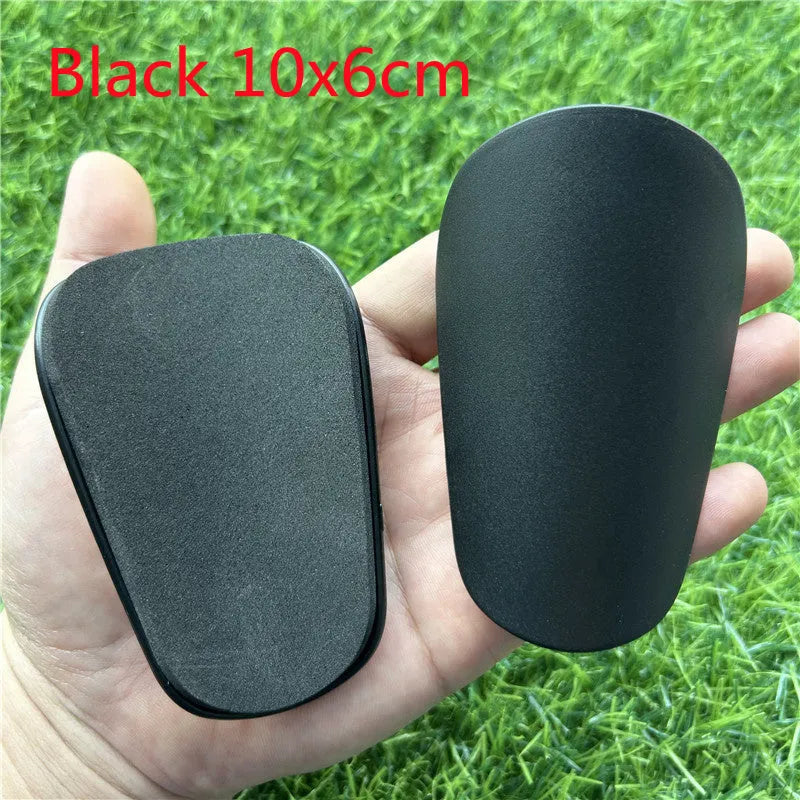 Black and white extra small plastic football shin guards for junior players